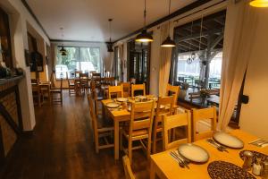 a dining room with wooden tables and chairs at JoValiMarAnt in Mikołajki