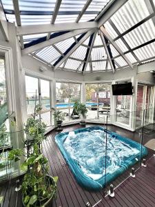 a hot tub in a house with a glass ceiling at 'Wallan luxury house in Wallan +72 photos