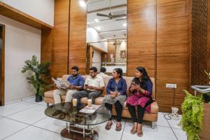 a group of people sitting on a couch at FabHotel Neelkamal - Chembur in Mumbai