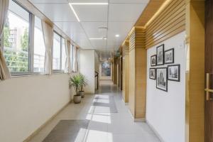 a hallway of an office building with windows at FabHotel Neelkamal - Chembur in Mumbai