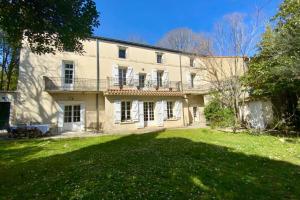 an exterior view of a large house with a yard at La Villa de l'Horloge - Family in Montpellier! in Montpellier +36 photos