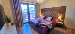 a bedroom with a large bed and a large window at Apartmanica apartments in Galileo, Donovaly, Low Tatras in Donovaly