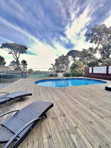 a swimming pool with two lounge chairs on a wooden deck at 'Wallan luxury house in Wallan