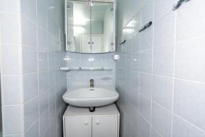 a white bathroom with a sink and a mirror at Sommerliebe in Hansaland +20 photos