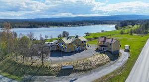 an aerial view of a house next to a lake at Brinkeboda Wärdshus in Mörsil