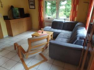 a living room with a couch and a table at Waldwiese RE15 in Sögel