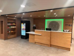 a lobby with a counter and a green wall at Comfort Inn Downtown Charleston in Charleston