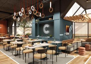 a restaurant with tables and chairs in a room at ibis Styles Colombes Paris Ouest (Ouverture Octobre 2025) in Colombes