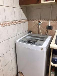 a washer and dryer in a corner of a kitchen at Casa Parque Krahmer in Valdivia