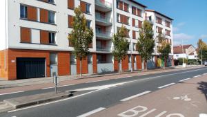 an empty street in front of a building at Air-conditioned 2 bedroom duplex apartment 5 people in Villefranche-sur-Saône