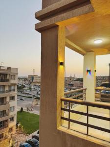 a balcony with a view of a parking lot at Madinty Stylish Stay in B6 in Madinaty