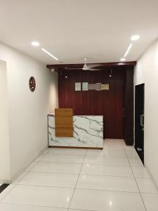 a room with a hallway with a door and a table at Hotel Skyline in Dholka