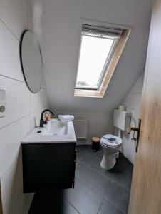 a bathroom with a sink and a toilet at Apartment 3 , Küche, WLAN, Parkplatz in Twist