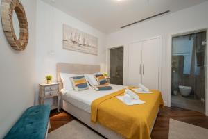 a bedroom with a large bed and a bathroom at Villa Picholine in Jakišnica +43 photos