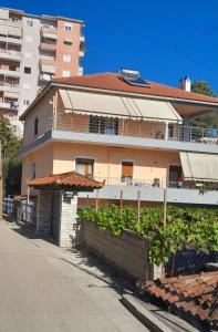 a building with a fence in front of it at George 1 in Gjirokastër