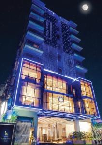 a building with a clock on the side of it at Marco Polo Dhaka in Dhaka