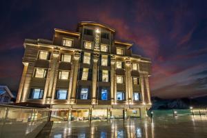 a large building with lights on it at night at ARCO Hotels and Resorts Srinagar in Srinagar