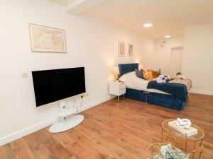 a living room with a couch and a tv at Two in Peterborough