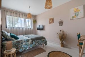 a bedroom with a bed and a window at Les loges de Pérelle in Chozeau