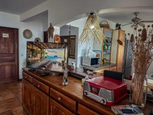 a room with a dresser with a television on it at KazaSunsetCat in Vieux-Habitants