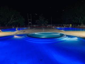 a blue basketball court at night with blue lights at Manthali Park Inn in Rāmechhāp
