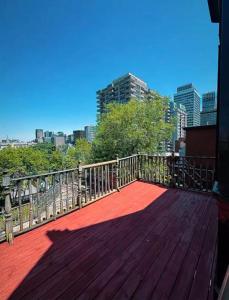 a wooden deck with a view of a city at 4BR Penthouse - Parking - 2 King & 2 Queen in Montréal