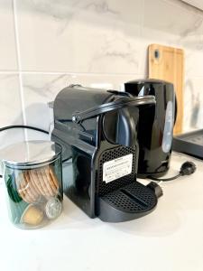 a coffee maker sitting on top of a counter at Cocon tout confort à 25 min de Paris in Sevran