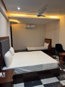 a hotel room with a bed and a ceiling at Burn Hall view Hotel in Abbottabad