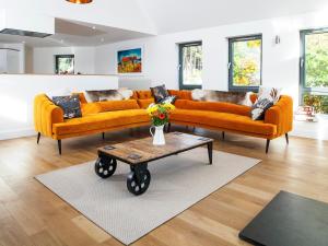 a living room with two couches and a coffee table at Strathspey Lodge in Duthil