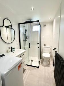 a bathroom with a shower and a toilet and a sink at Cocon tout confort à 25 min de Paris in Sevran +24 photos