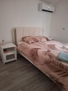 a bedroom with a bed and a night stand at Ateka Dax in Dax +17 photos