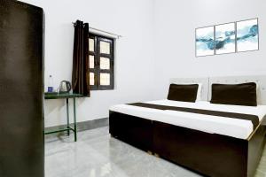 a bedroom with a large bed in a room at Indian Hotel in Bareilly