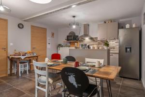 a kitchen and dining room with a table and chairs at Les loges de Pérelle in Chozeau