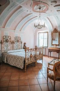 a bedroom with a bed and a chandelier at Cascina Bringin in Mondovì
