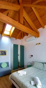 a bedroom with a bed and a wooden ceiling at Adda River Tower Room in Calolziocorte