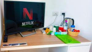 a computer monitor sitting on top of a desk at Adda River Tower Room in Calolziocorte