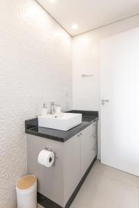 a white bathroom with a sink and a toilet at Cozy 2 Br In Ciudad Del Este in Puerto Presidente Franco