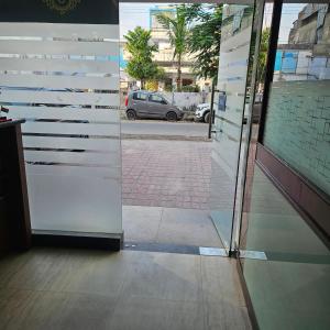 an open door of a building with a view of a street at Hotel Indra in Jaipur