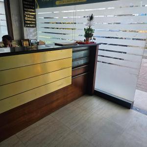 a counter in a restaurant with a potted plant at Hotel Indra in Jaipur