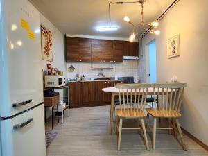 a kitchen and dining room with a table and chairs at Rosemary in Seoul