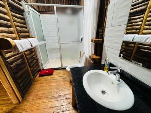 a bathroom with a white sink and a shower at The Great Outdoors Uganda in Vumba +84 photos