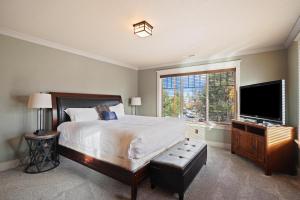 a bedroom with a bed and a flat screen tv at Awbrey in Bend