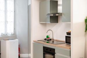 a small kitchen with a sink and a refrigerator at Vertical Garden Studio by Quokka 360 - Modern studio in Como Downtown in Como