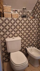 a bathroom with a white toilet and a sink at Casa XIII in Costa del Este +13 photos