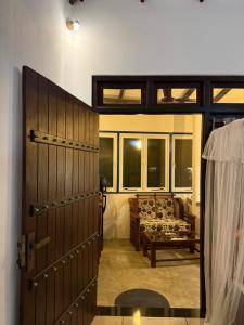 a door leading to a living room with a couch at Taco Super Place in Unawatuna