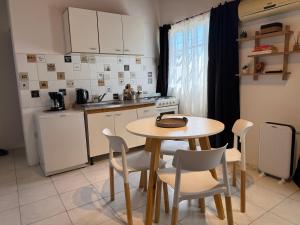 a kitchen with a table and chairs in a kitchen at MerloINK3 in Merlo +38 photos