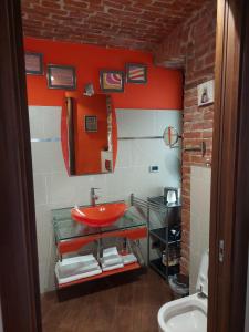 a bathroom with a red sink and a mirror at Ladyemma in Turin