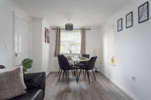 a living room with a table and chairs at Peaceful, Perfect for Work, Leisure, Free Parking in Bletchley