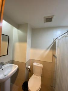 a bathroom with a toilet and a sink at Persimmon Studios Tower 3 in Cebu City