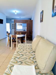 a living room with a couch and a dining room at Apart Hotel Bell in San Fernando del Valle de Catamarca